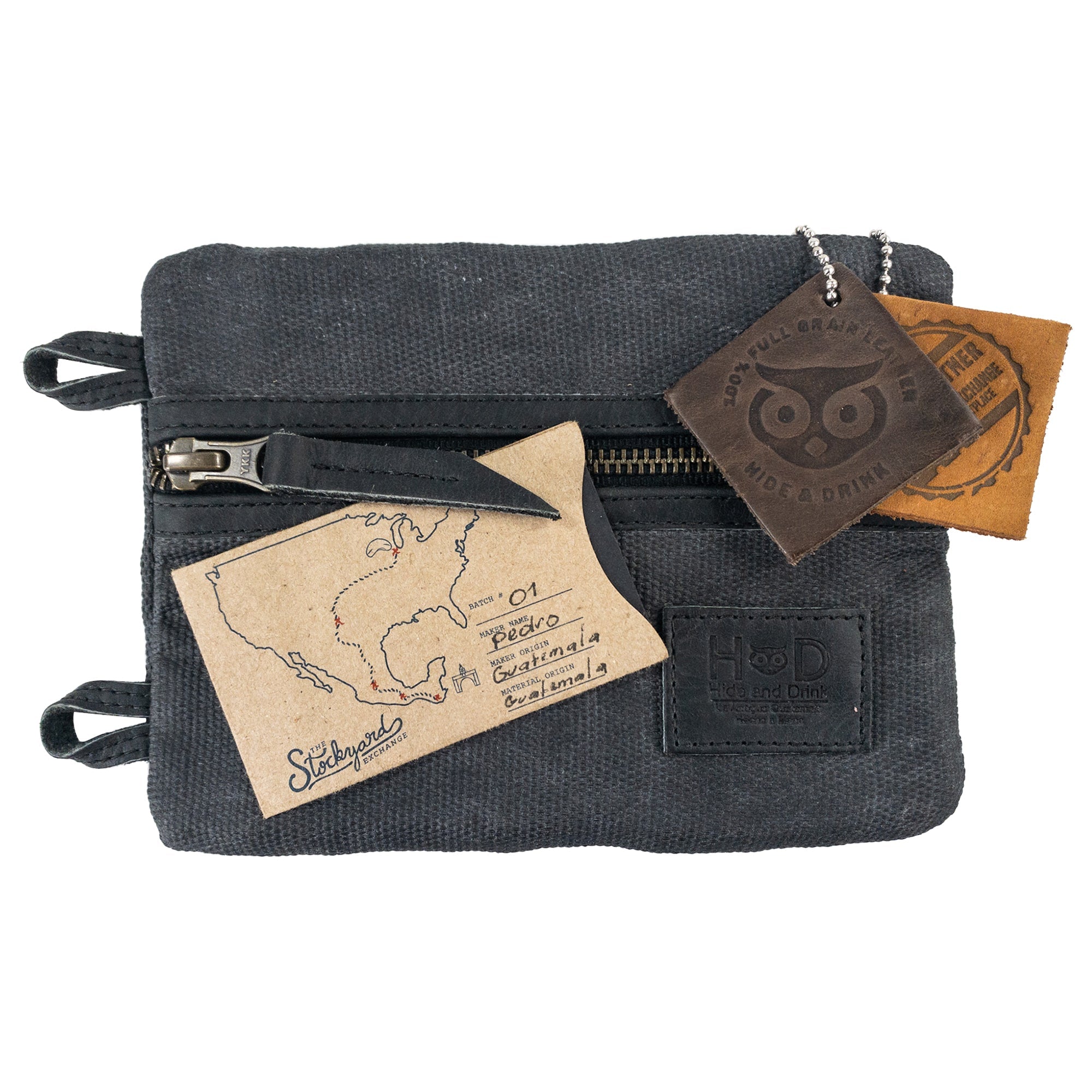 Multi-tool Pocket Pouch - XL by Hide & Drink displayed in a stylish arrangement with a business card, a perfect choice for gifting enthusiasts or practical use for tools. Multi-Tool Pocket Pouch XL, Compact Multipurpose EDC Zippered Bag, Knife Holster, Handmade Slim Organizer, Waxed Canvas, StockyardX, Small Batch Production, Artisan, Handmade in La Antigua Guatemala & Oaxaca Mexico.