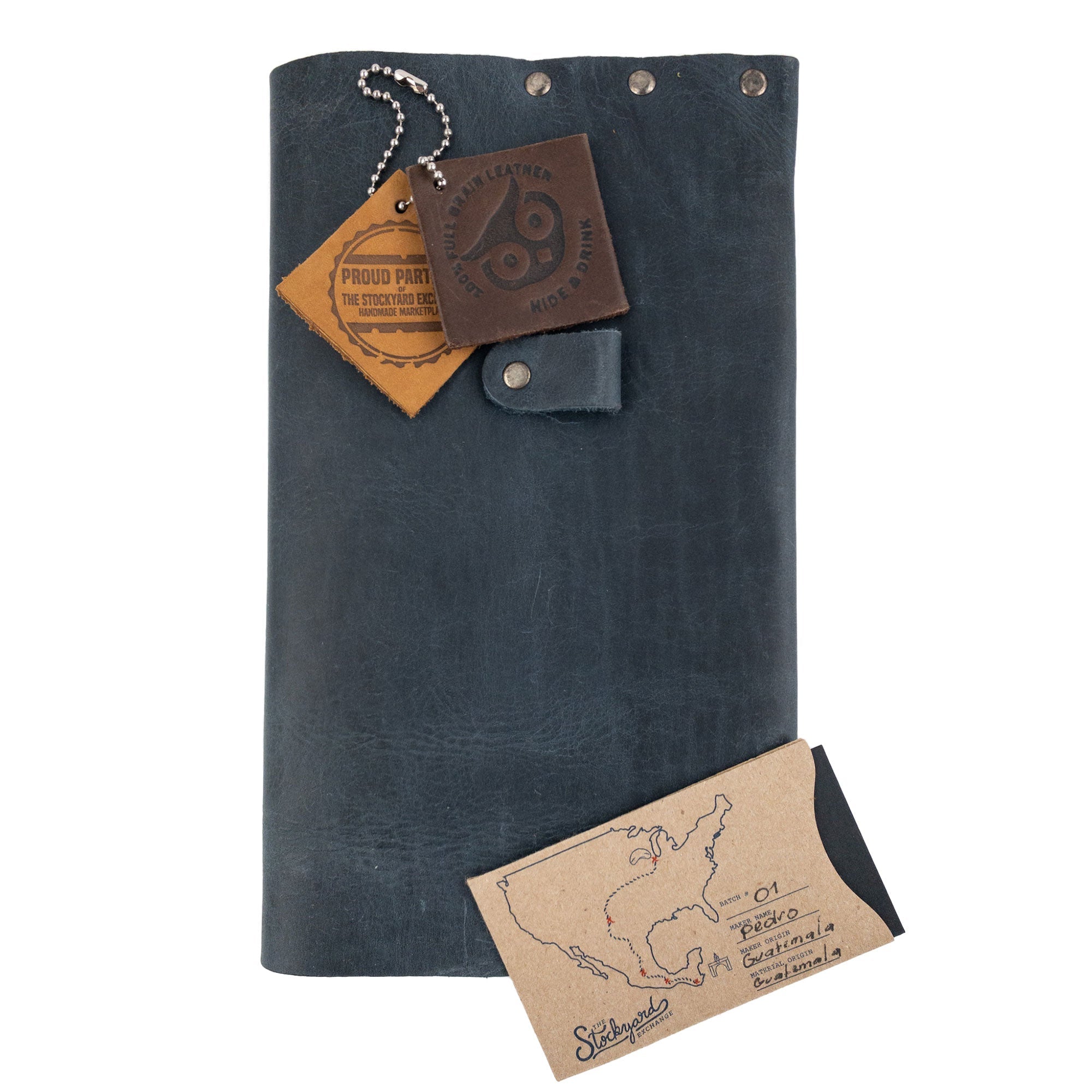 Riveted Journal Cover (5 x 8.50 in.) by Hide & Drink presented with tags and accessories, showcasing its vintage style and full grain leather. This artisan-made item boasts small batch production and is handmade in La Antigua Guatemala & Oaxaca Mexico.