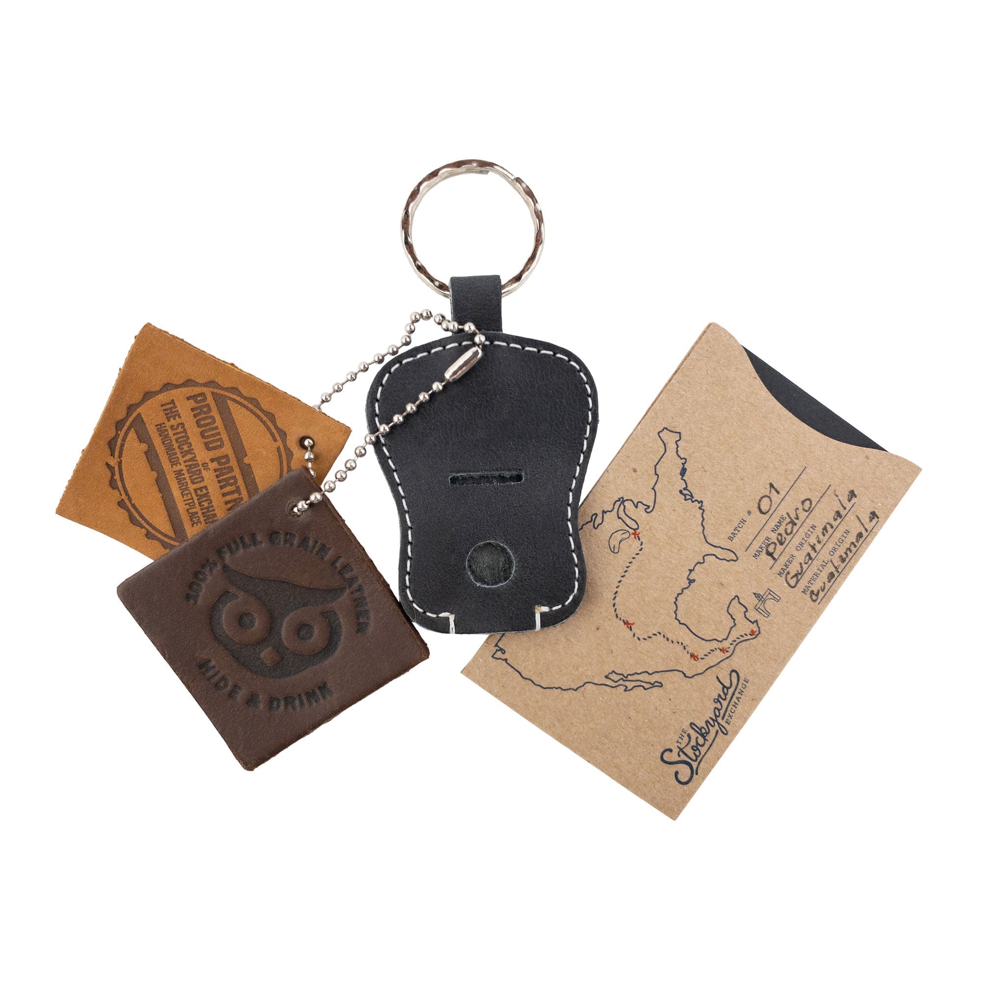 Guitar Keychain by Hide & Drink displayed with packaging, featuring its artisan quality. This handcrafted key holder, made from Full Grain Leather, emphasizes small batch production from skilled artisans in La Antigua Guatemala & Oaxaca Mexico.