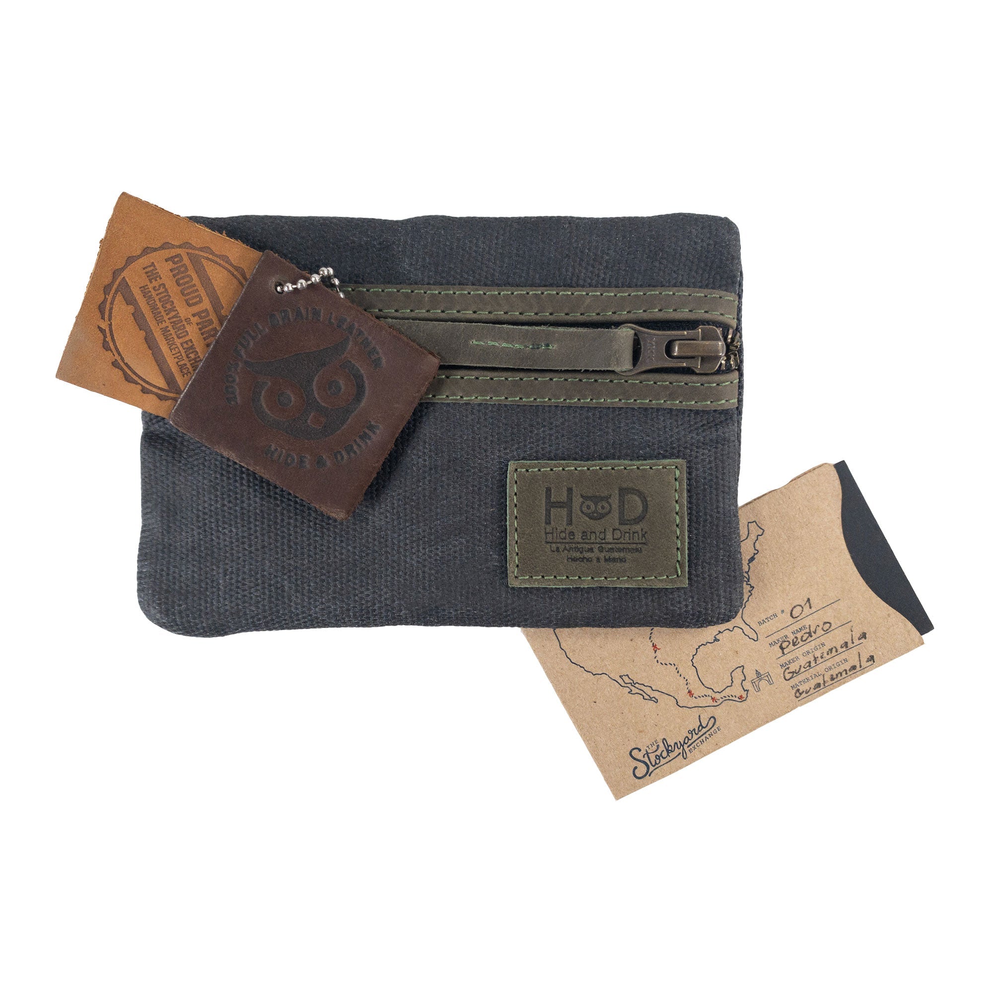 Packaging of the navy Multi-tool Pocket Pouch by Hide & Drink, featuring artisan production tags emphasizing its quality.