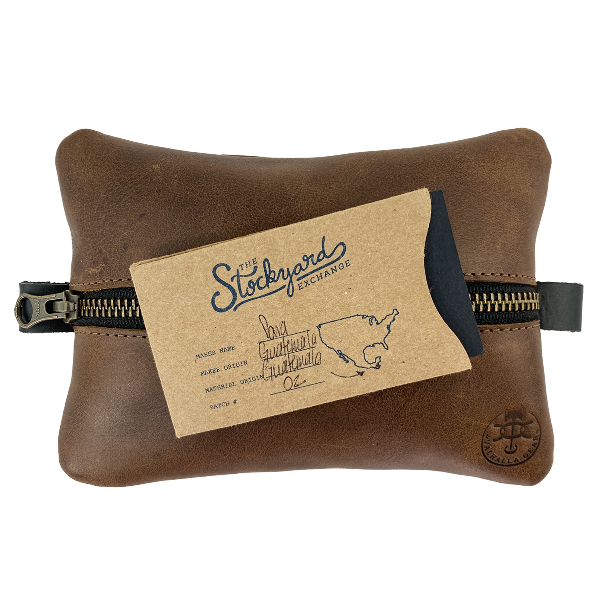 The EDC Zippered Pouch by Valhalla Gear, complete with care instructions, reflecting its unique handmade quality. This accessory bag made from full grain leather is designed for storing small personal items and tools, showcasing artisan craftsmanship through small batch production in La Antigua Guatemala.