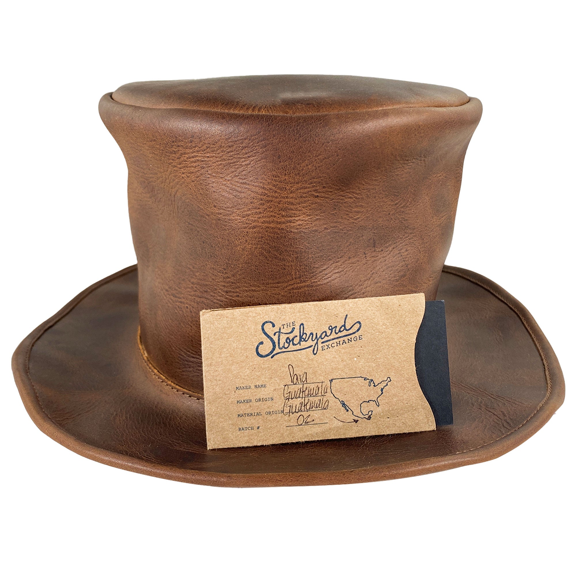A captivating view of the Hide & Play Top Hat with a label, symbolizing its artisanal authenticity and quality. This Top Hat, ideal for the Mad Hatter look, is perfect for cosplay, Halloween, performances, films, and shows. Crafted from full grain leather, it embraces small batch production, hand cut, hand sewn creation, along with fire branding by artisans in La Antigua Guatemala and Oaxaca Mexico.