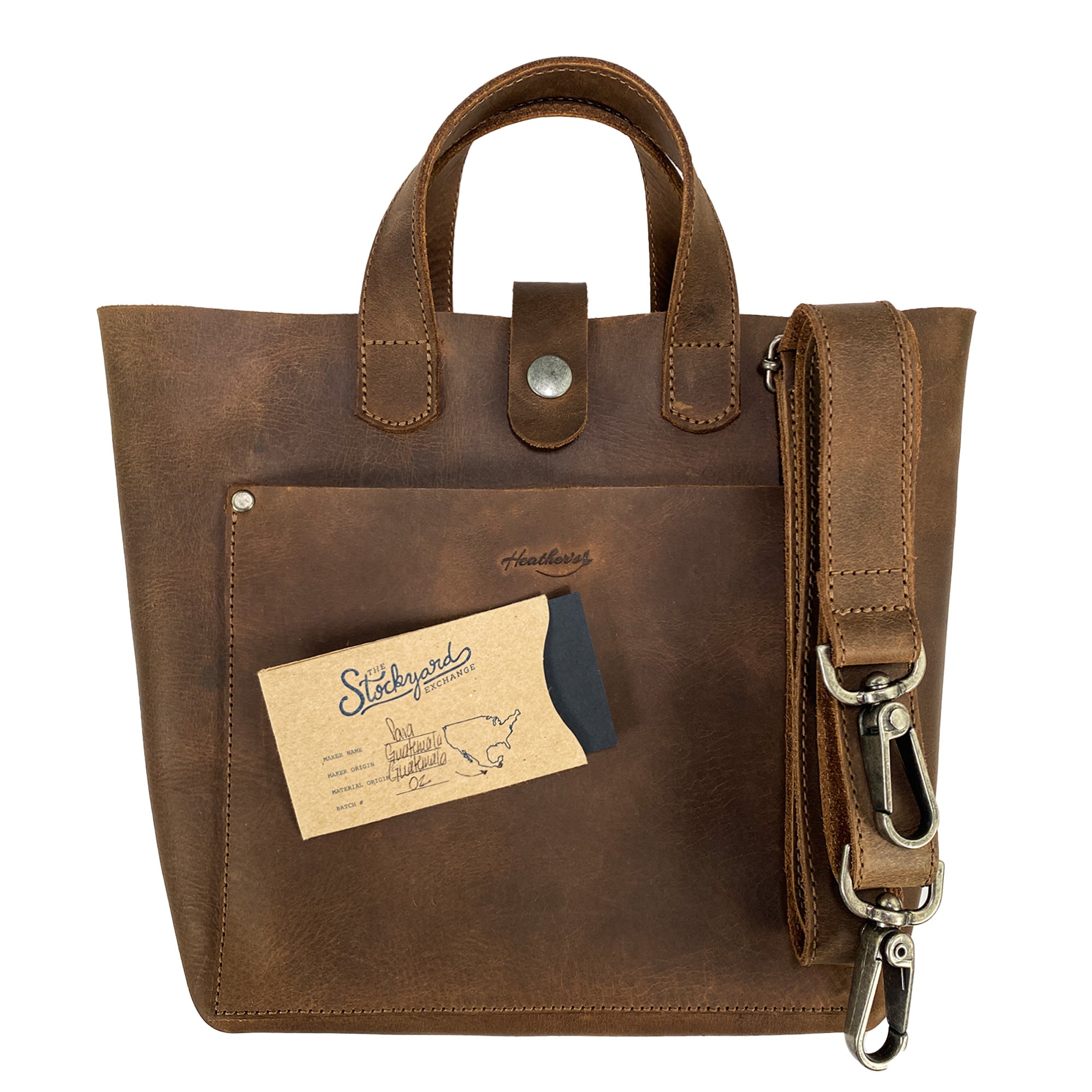 Heather's Crossbody Tote Bag with Pouch, featuring a front pocket and artisan details, this rustic handbag reflects vintage style and functionality for travel and shopping. Made from full grain leather, it's handmade in La Antigua Guatemala & Oaxaca Mexico, showcasing quality small batch production.