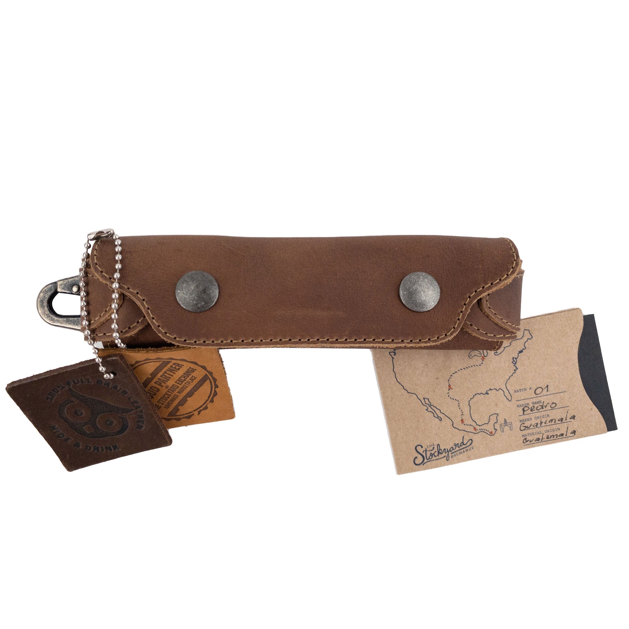 Harmonica Case by Hide & Drink with tags attached, showcasing its unique artisan craftsmanship. Made from durable full grain leather, this vintage style instrument cover is ideal for musicians, emphasizing small batch production quality.