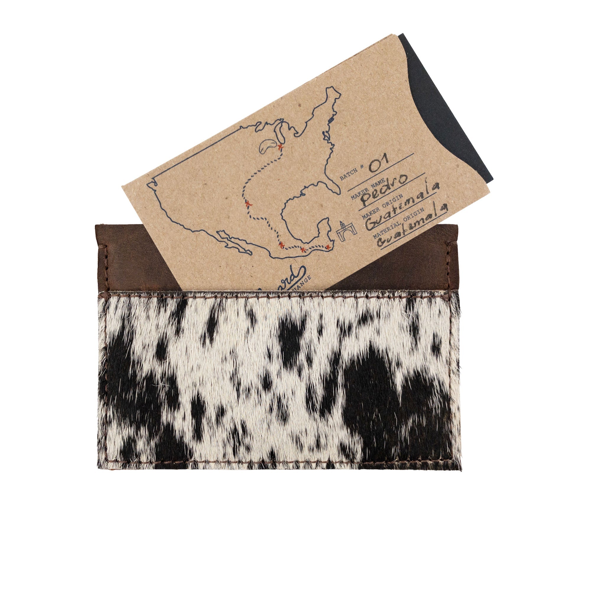 Western Leather Works Double Card Wallet with a card and a map, highlighting its utility. This artisan piece serves as compact storage and an ID holder, made from premium full grain leather in La Antigua Guatemala. The wallet is hand cut and hand sewn, emphasizing small batch production and fire branded artistry.