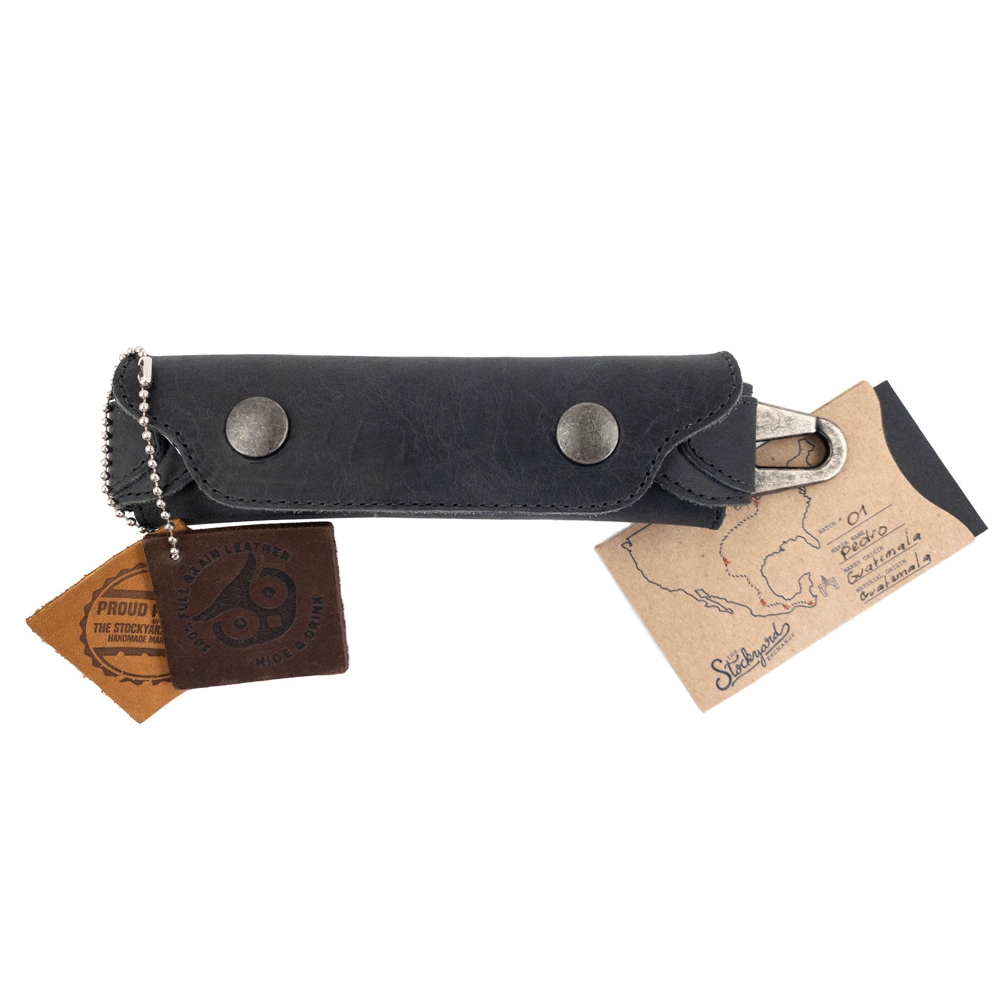 Harmonica Case from Hide & Drink with tags attached, showcasing its unique artisan quality. Made from durable full grain leather, this vintage style instrument cover is an essential for musicians, representing small batch production from La Antigua Guatemala.