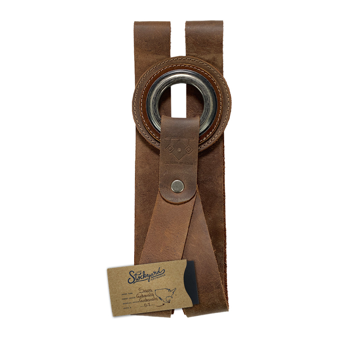 A detailed image of the Book Wall Hanger by Leather At Home exhibiting its rustic charm and full grain leather. This unique wall organizer is designed for book lovers, making it a must-have for organizing comics and magazines. Artisan-crafted in La Antigua Guatemala & Oaxaca Mexico, it showcases small batch production.