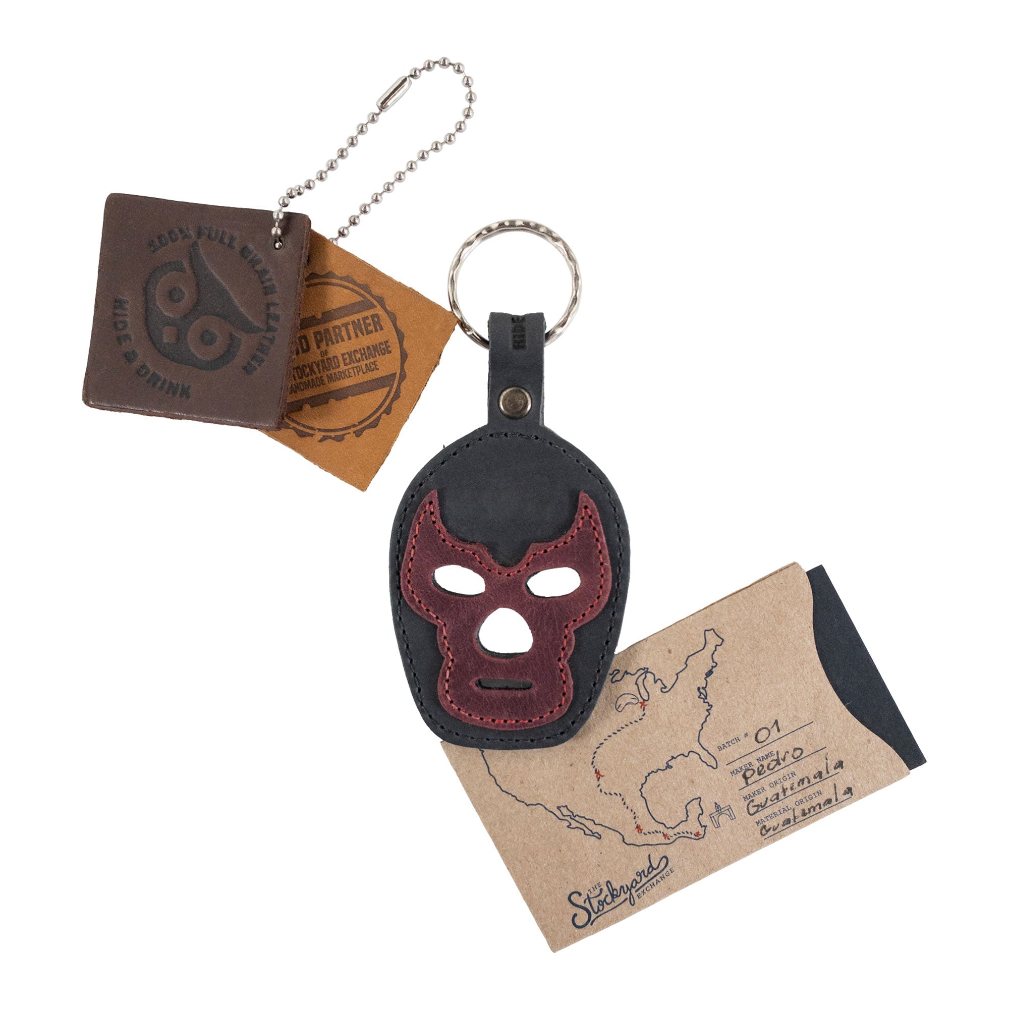 Close-up of the Luchador Mask Leather Keychain, revealing the unique craftsmanship and design. This keyring from Hide & Drink serves as a key organizer made from full grain leather, reflecting the value of small batch production. Each piece is hand cut and hand sewn by artisans in La Antigua Guatemala and Oaxaca Mexico.