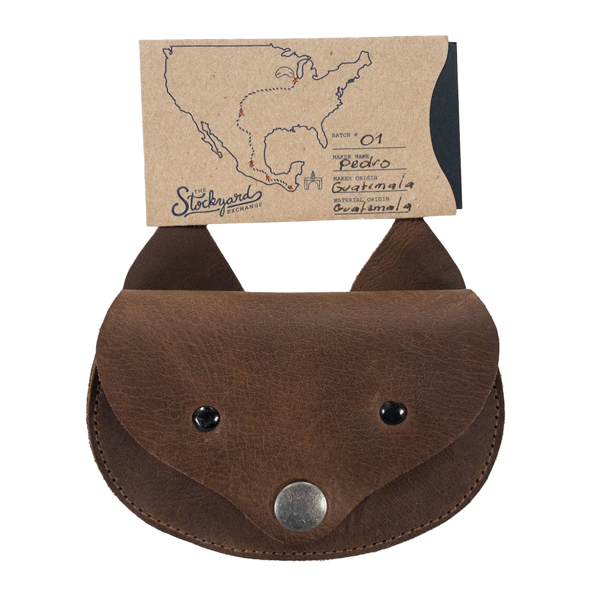 The Foxy Head Shape Coin Pouch by Hide & Play, packaged with a map highlighting the handmade origin. Crafted in Full Grain Leather, this piece reflects small batch production, hand cut, and hand sewn techniques, accompanied by fire branding that showcases artisan traditions from La Antigua Guatemala & Oaxaca Mexico.