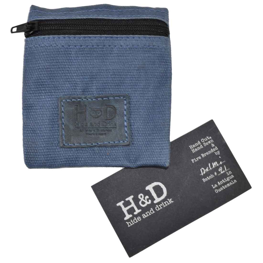 Hide & Drink Condom Pouch filled with coins and keys, designed with durable water resistant waxed canvas. This pouch is perfect for organizing valuables, ideal for being a classic partner gift. Handmade in La Antigua Guatemala showcases exceptional artisan skills.