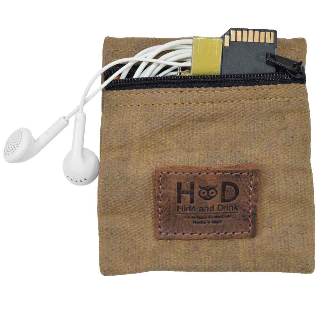 Hide & Drink Condom Pouch with earphones and a memory card, constructed from water resistant waxed canvas. This versatile pouch serves as a convenient tech pocket and makes a classic partner gift. Perfect for travel and honeymoon essentials; handmade in La Antigua Guatemala with small batch, artisan excellence.