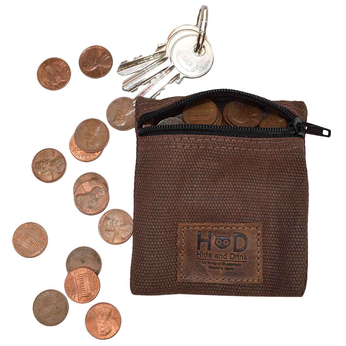 Hide & Drink Condom Pouch containing coins and keys, designed from durable water resistant waxed canvas. Perfect for organizing change or valuables, this artisan pocket purse makes for a classic partner gift. Ideal for travel and honeymoon essentials, showcasing handmade quality from La Antigua Guatemala.