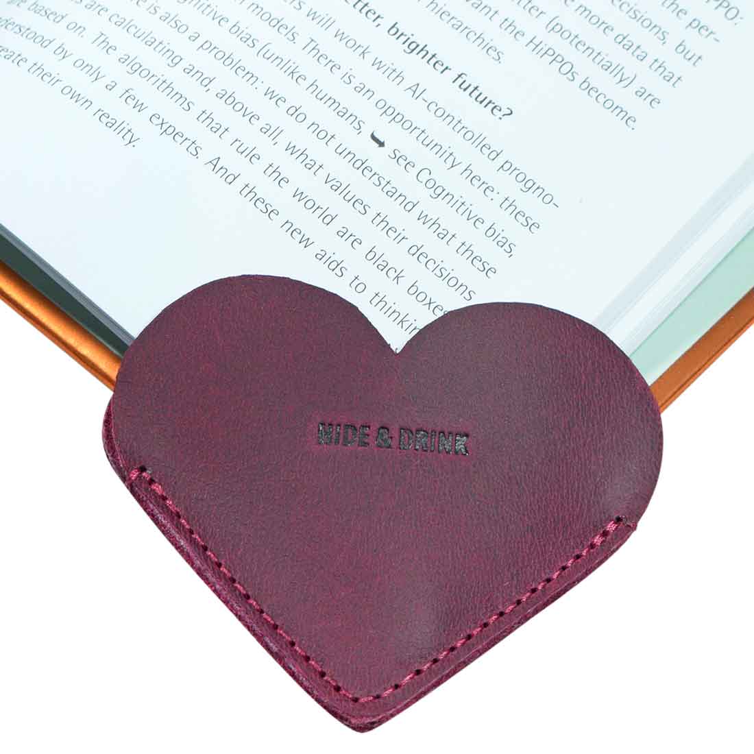 View of a burgundy Leather Corner Heart Bookmark (2 pack) by Hide & Drink, crafted with Full Grain Leather for a premium feel. This artisan product is handcrafted in La Antigua Guatemala and Oaxaca Mexico, emphasizing attention to detail.