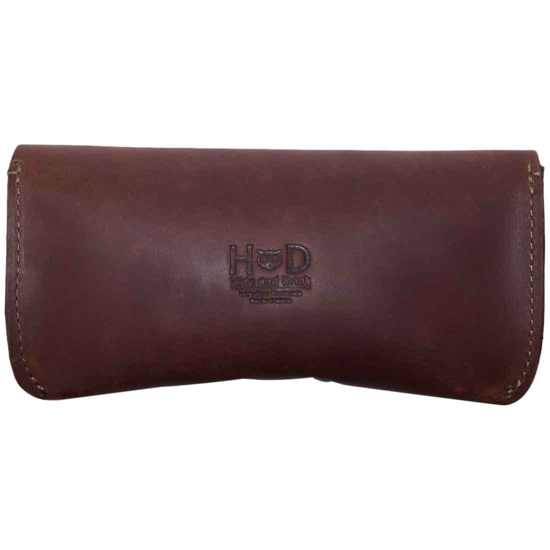 Thick Eyeglasses Case by Hide & Drink displaying the logo, made from quality Thick Sturdy Leather. This handmade case is perfect for storing 6-inch long glasses, offering durable protection as an eyewear sunglasses holder, crafted from full grain leather with small batch artisan techniques in La Antigua Guatemala & Oaxaca Mexico.