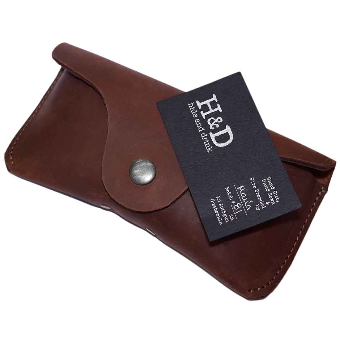 Thick Eyeglasses Case by Hide & Drink with a tag, showcasing the quality of the Thick Sturdy Leather design. This case is perfect for 6-inch long glasses, acting as an eyewear-sunglasses protector. Made from full grain leather, it highlights small batch production and artisan craftsmanship from La Antigua Guatemala & Oaxaca Mexico.
