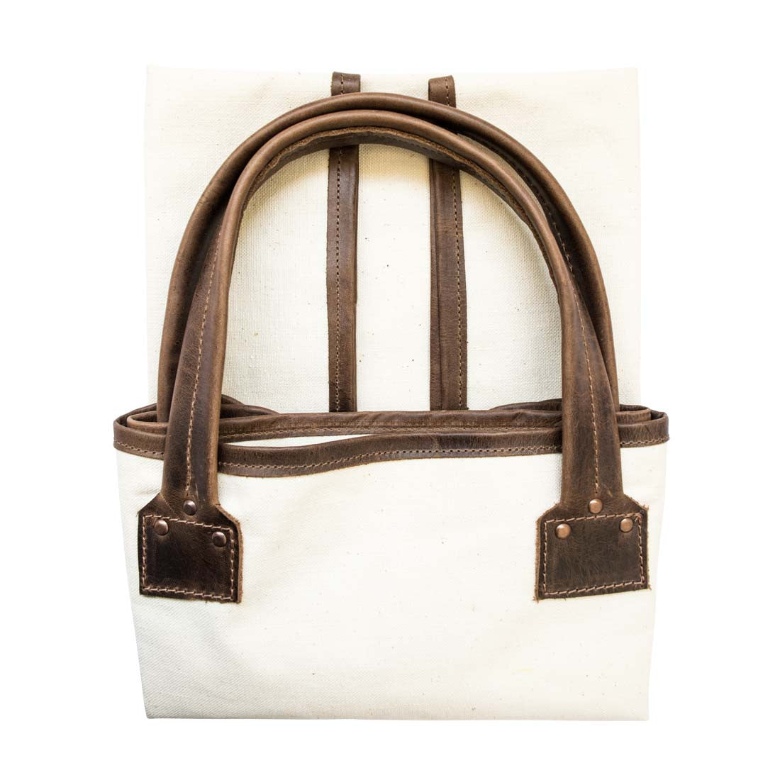 Hide & Drink Firewood Bag with handles laid flat, illustrating the quality craftsmanship and rustic appeal of the design. Firewood Bag With Leather Liner, Full Grain Leather, StockyardX, Small Batch Production, Hand Cut, Hand Sewn, Fire Branded, Artisan, Handmade in La Antigua Guatemala & Oaxaca Mexico.