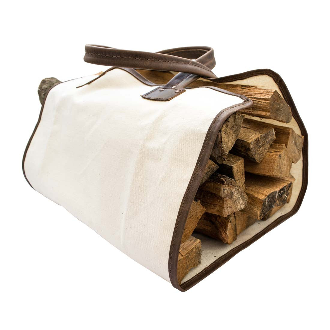 Hide & Drink Firewood Bag featuring stacked firewood, showcasing the durable design made from strong raw canvas and full grain leather handles. Firewood Bag With Leather Liner, Full Grain Leather, StockyardX, Small Batch Production, Hand Cut, Hand Sewn, Fire Branded, Artisan, Handmade in La Antigua Guatemala & Oaxaca Mexico.