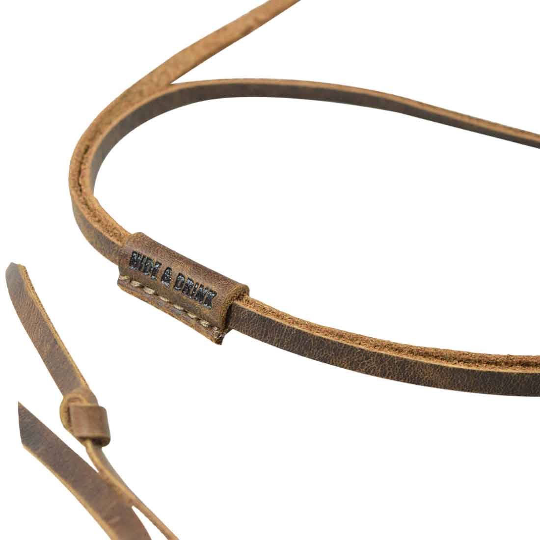 Close-up of Hide & Drink's leather glasses strap, showcasing the fine craftsmanship and hand-stitched quality inherent in their products. This Glasses Strap is an adjustable accessory made from durable Full Grain Leather, demonstrating the artisan skill from small batch production in La Antigua Guatemala & Oaxaca Mexico.