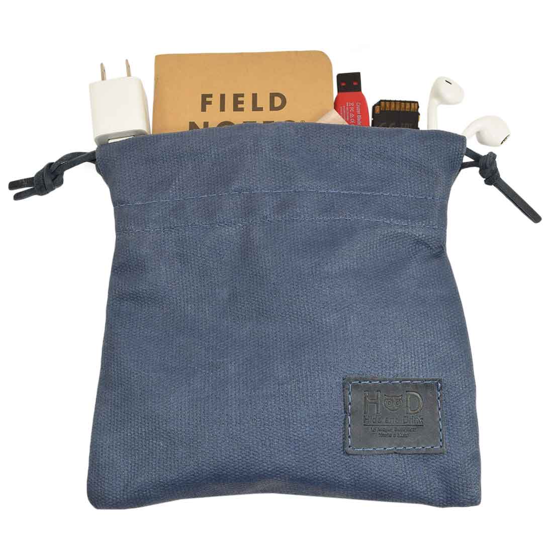 The Hide & Drink Golf Pouch featuring a business card, showcasing elegant design and craftsmanship. This waxed canvas pouch is great for keeping golf essentials organized. Waxed Canvas Golf Valuables Field Pouch, Golf Bag, Sport Organizer, Multipurpose Pouch with String, StockyardX, Small Batch Production, Hand Cut, Hand Sewn, Fire Branded, Artisan, Handmade in La Antigua Guatemala & Oaxaca Mexico.