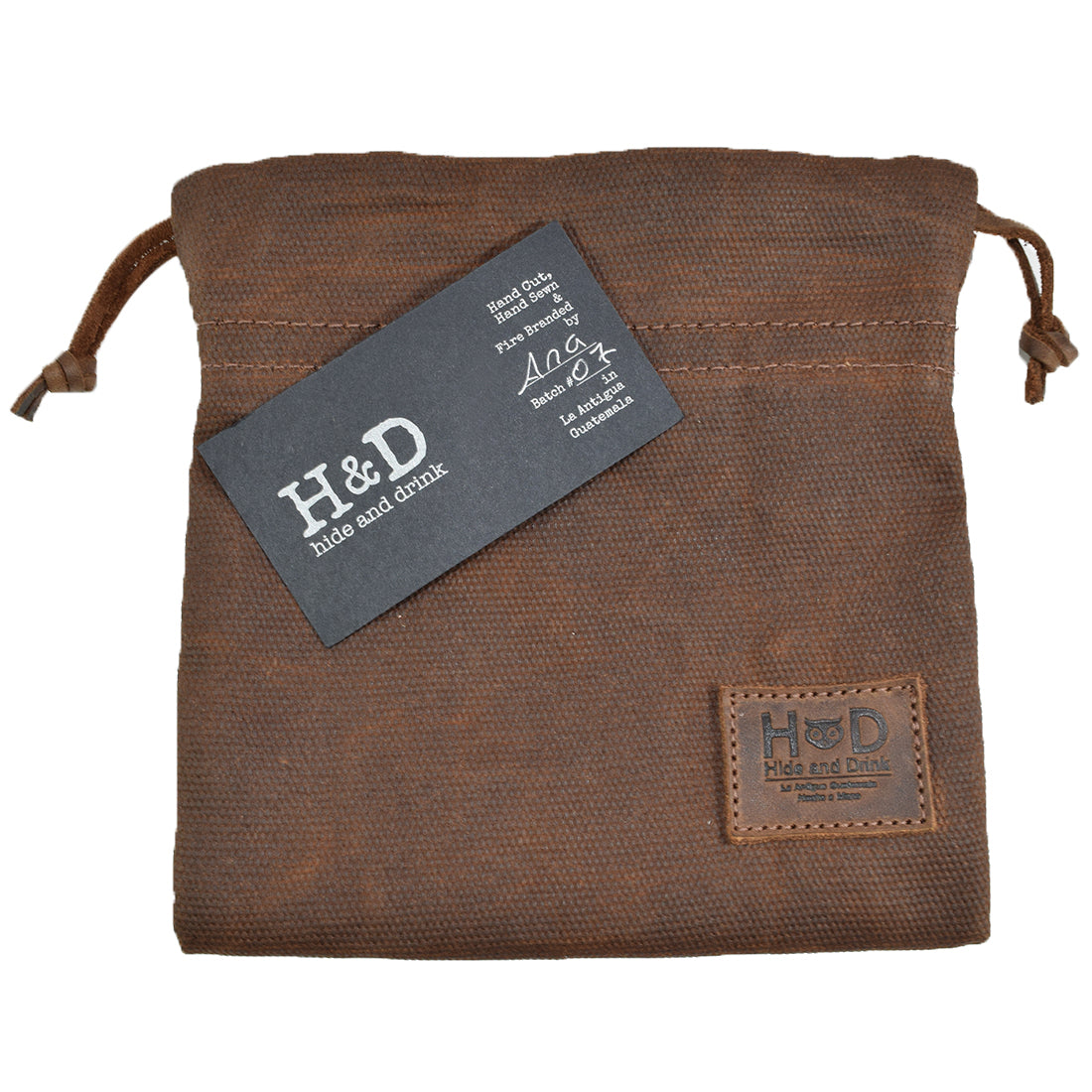 Hide & Drink Golf Pouch displaying a business card, showcasing its stylish design and practicality. Made from durable waxed canvas, this pouch is great for organizing valuables in your golf bag. Waxed Canvas Golf Valuables Field Pouch, Golf Bag, Sport Organizer, Multipurpose Pouch with String, StockyardX, Small Batch Production, Hand Cut, Hand Sewn, Fire Branded, Artisan, Handmade in La Antigua Guatemala & Oaxaca Mexico.