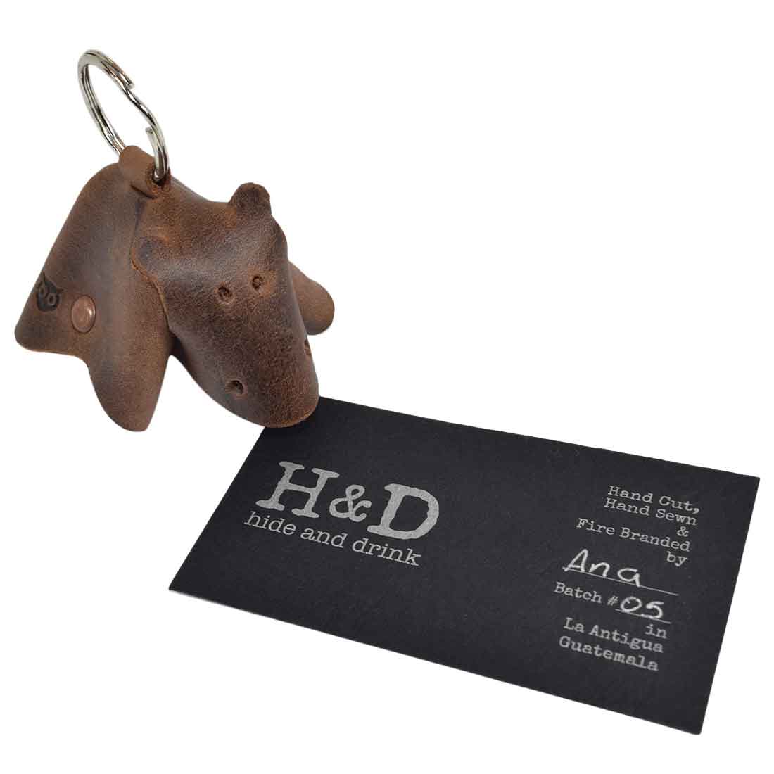 Genuine Full Grain Leather Animal Key Chain by Hide & Drink, showcasing a delightful cow design along with a brand tag. This handcrafted Critter Keychain works as both a fob charm and animal key holder charm pendant, emphasizing artisan small batch production.