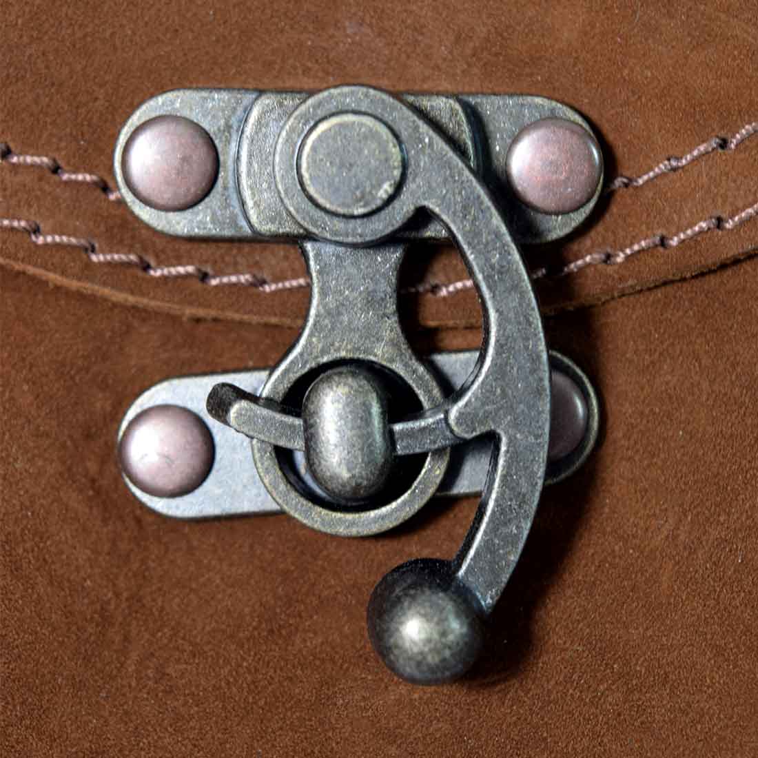 Close-up of the vintage clasp on a brown Vintage Clutch Bag from Hide & Drink, illustrating the Full Grain Leather quality. An artisan piece created through small batch production in Oaxaca Mexico.