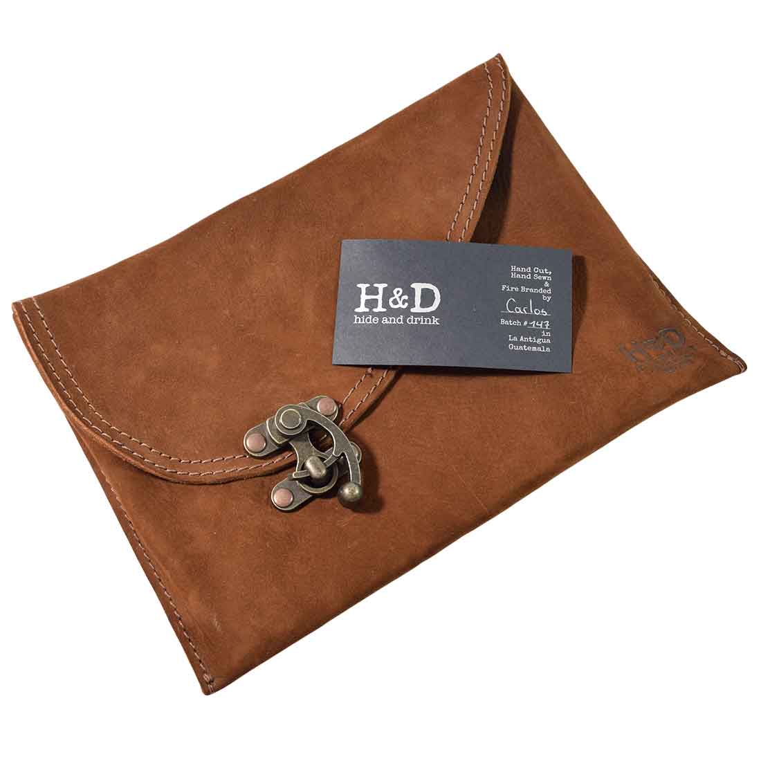 Pricing and details tag for a Vintage Clutch Bag from Hide & Drink, emphasizing the Full Grain Leather craftsmanship and artisan production in Oaxaca Mexico.