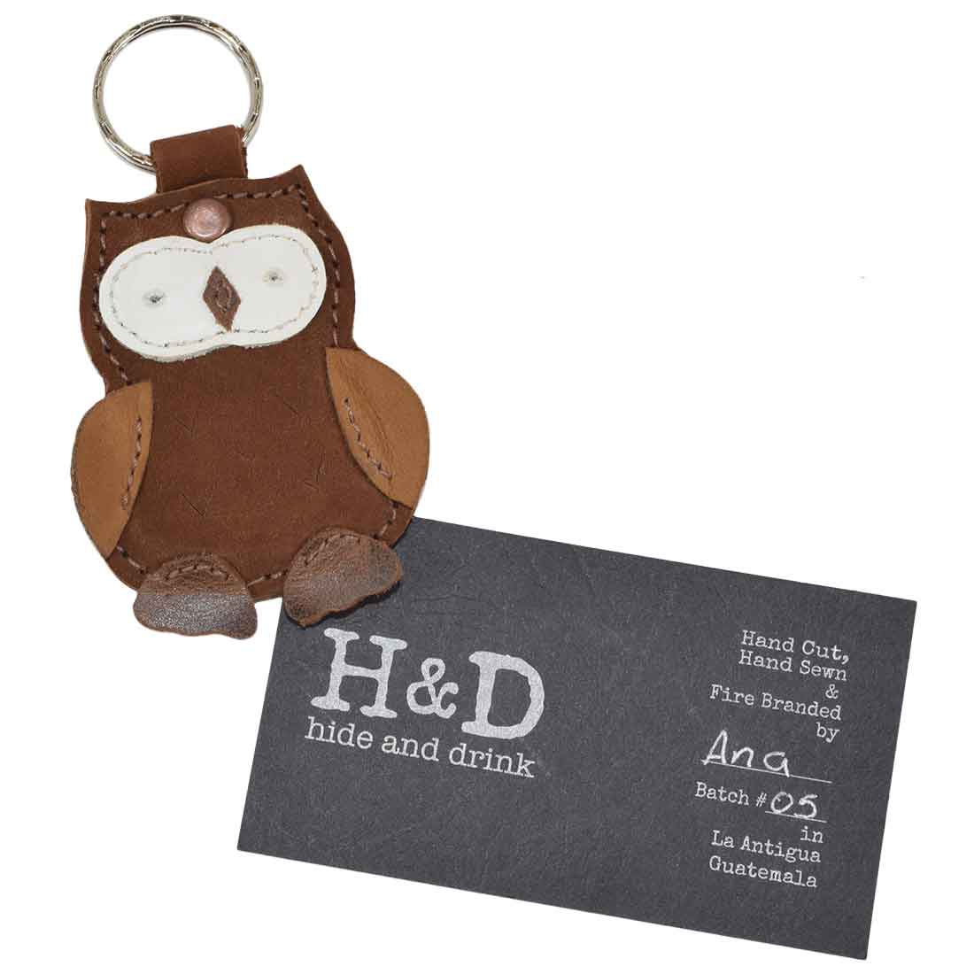 Owl Critter Key Chain by Hide & Drink with accompanying brand card, showcasing the artisan's craftsmanship. A perfect Animal Key Ring Holder made from Full Grain Leather that blends function and fun. Handmade in La Antigua Guatemala & Oaxaca Mexico.