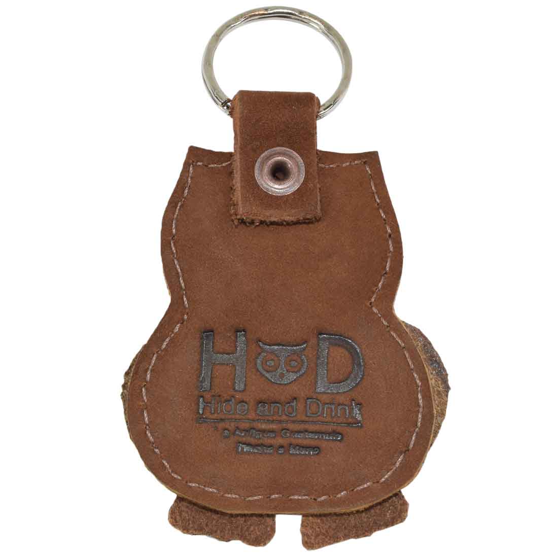 The back view of the owl Critter Key Chain by Hide & Drink, highlighting its Fire Branded logo. This unique Animal Key Ring Holder adds a rustic flair while being crafted from durable Full Grain Leather. Handmade in La Antigua Guatemala & Oaxaca Mexico.