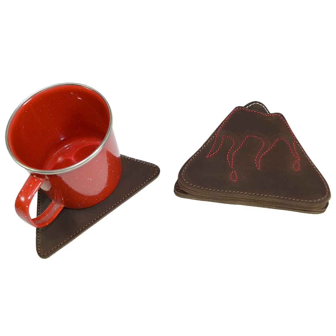 Displaying a Fire & Ice Volcano Mountains Set Coaster from the Hide & Drink Landscape Coasters Set (6-Pack) next to a vibrant mug. These coasters are made of Full Grain Leather and are hand cut and sewn, embodying the small batch production and artisan quality from La Antigua Guatemala & Oaxaca Mexico.