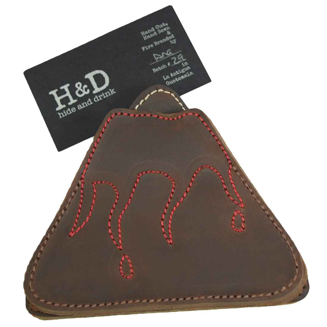 A close-up view of a Fire & Ice Volcano Mountains Set Coaster from Hide & Drink, featuring detailed stitching. Part of the Landscape Coasters Set (6-Pack), these coasters are crafted from Full Grain Leather, highlighting the artisan craftsmanship rooted in small batch production from La Antigua Guatemala & Oaxaca Mexico.