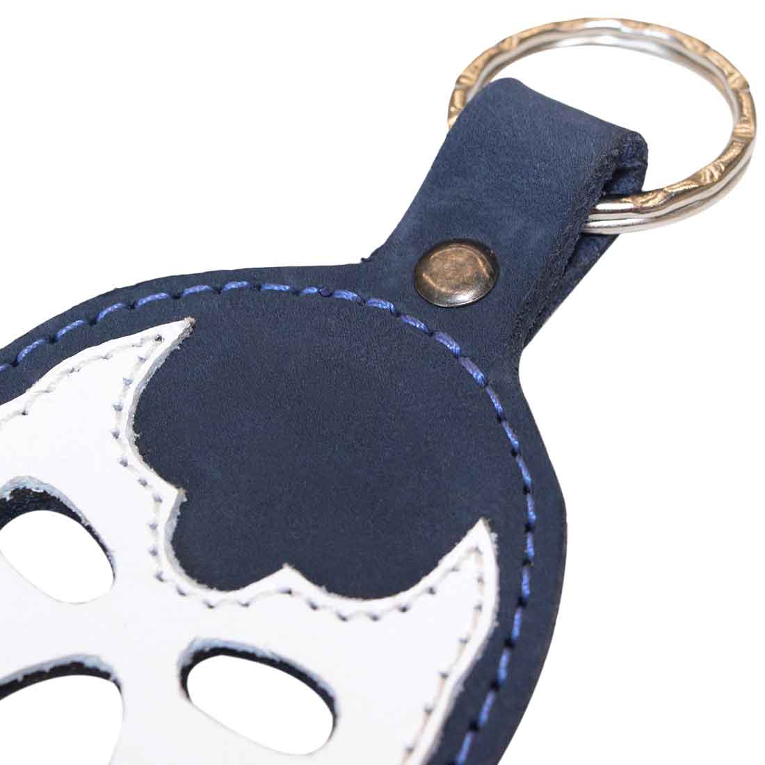 Close-up of the detailed Luchador Mask Leather Keychain in navy showing the fine stitching, perfect for those who appreciate quality. This keyring from Hide & Drink combines luxury with practicality as a key organizer. Made of full grain leather, this artisan product is hand cut and hand sewn in La Antigua Guatemala and Oaxaca Mexico, ensuring it’s a unique travel accessory.