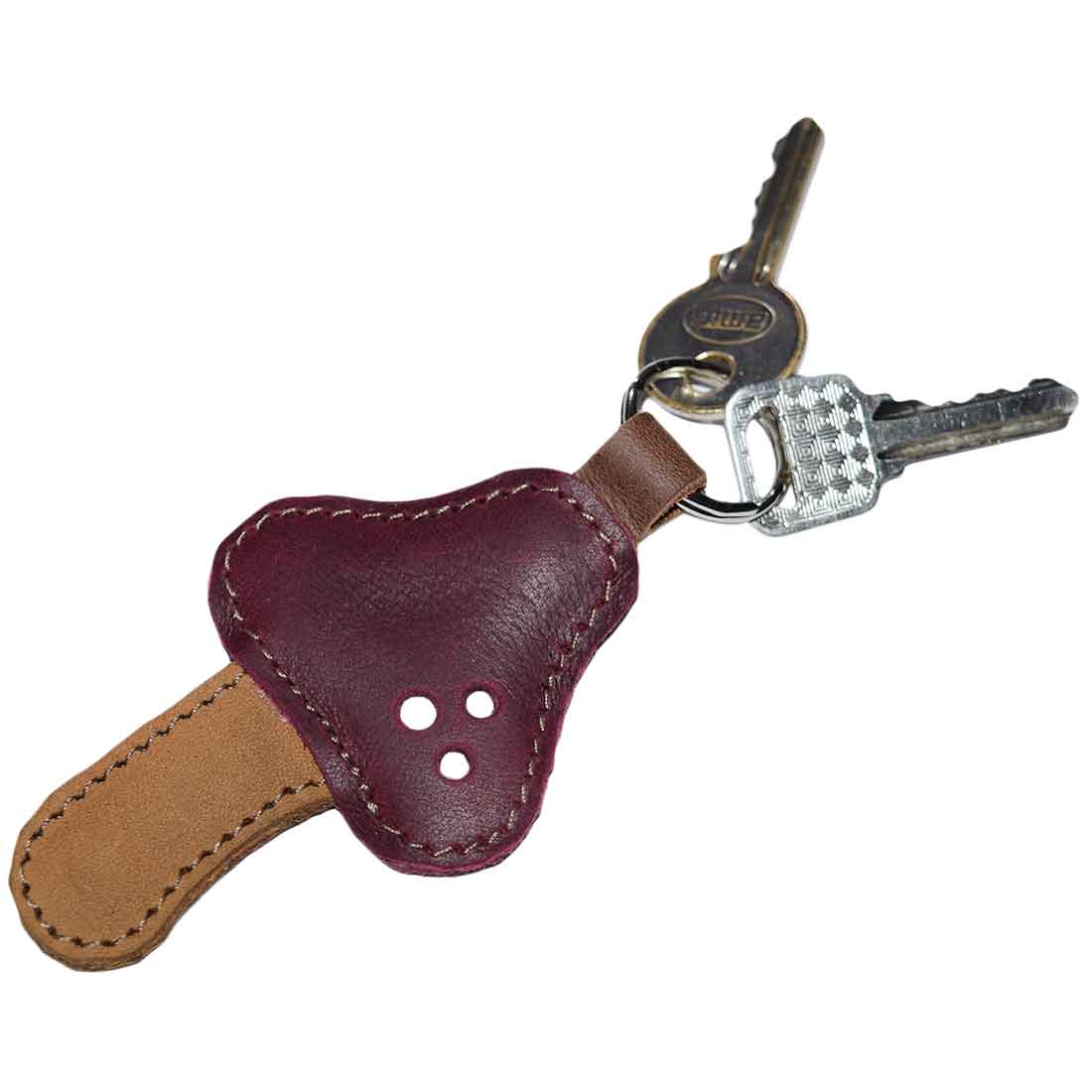 Close-up view of the Red Mushroom Keychain by Hide & Drink, showcasing its rich color and design. This Full Grain Leather keychain proves to be a stylish accessory with its artisan craftsmanship, part of StockyardX's small batch production. Hand cut and hand sewn, each piece is fire branded and handmade in La Antigua Guatemala & Oaxaca Mexico.