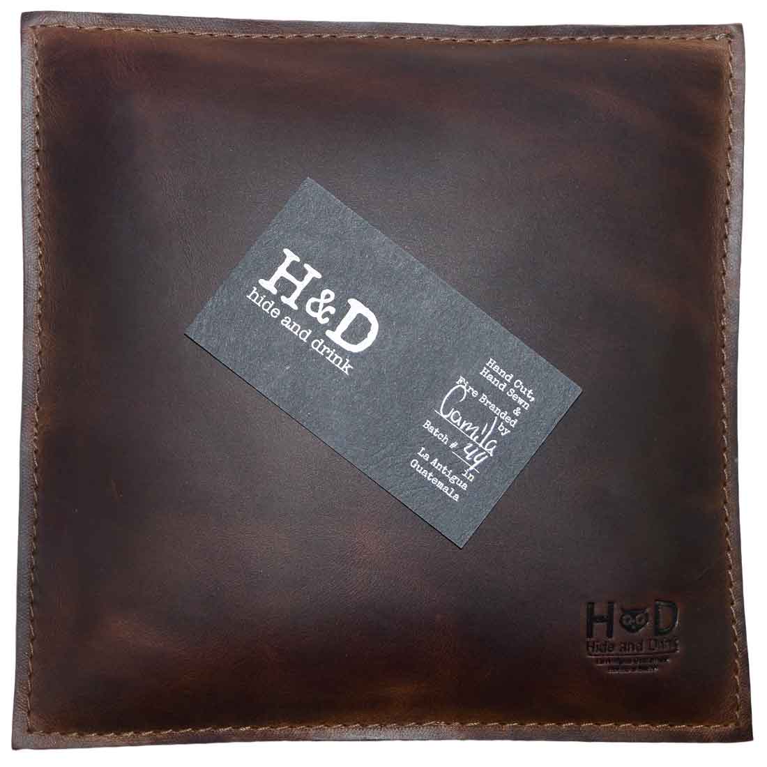 Hide & Drink Decorative Pillow crafted from beautiful full grain leather, a must-have 12 x 12 in. piece for couch, sofa, or bed. This stylish decoration is perfect for home and office accessories, showcasing small batch production, with each piece hand cut, hand sewn, and fire branded by artisans in La Antigua Guatemala & Oaxaca Mexico.