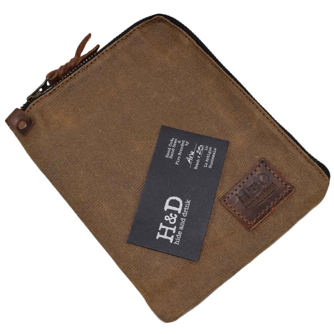 Brown Scribbler Case by Hide & Drink, showcasing Waxed Canvas construction. Ideal for holding notebooks, emphasizing small batch production, artisan craftsmanship, and fire-branded details. Handmade in La Antigua Guatemala & Oaxaca Mexico.