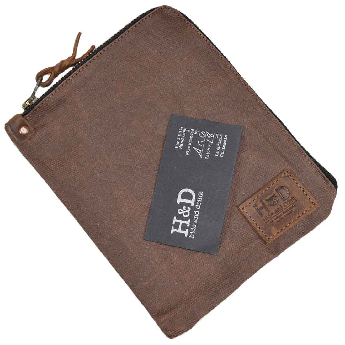 Front view of the black Scribbler Case from Hide & Drink, crafted from Waxed Canvas. Ideal for notebook storage, emphasizing small batch production and artisan quality. Handmade in La Antigua Guatemala & Oaxaca Mexico.