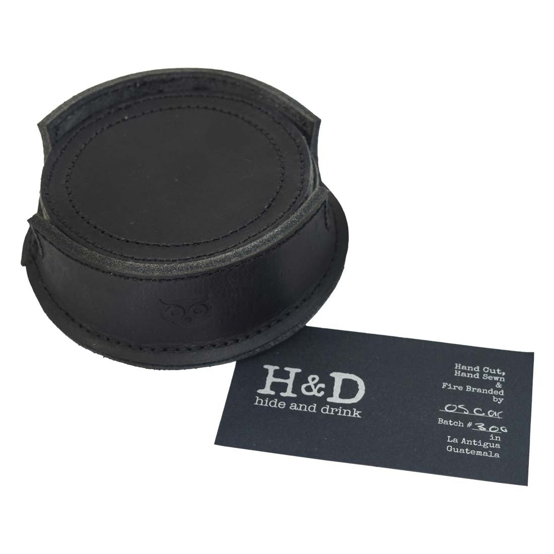 Thick Leather Coasters (6-Pack) by Hide & Drink displayed with a product card, highlighting the unique design of charcoal black circular coasters handmade from full grain leather. Each piece reflects artisan craftsmanship through small batch production, hand cut, hand sewn, and fire branded, thoughtfully created in La Antigua Guatemala.