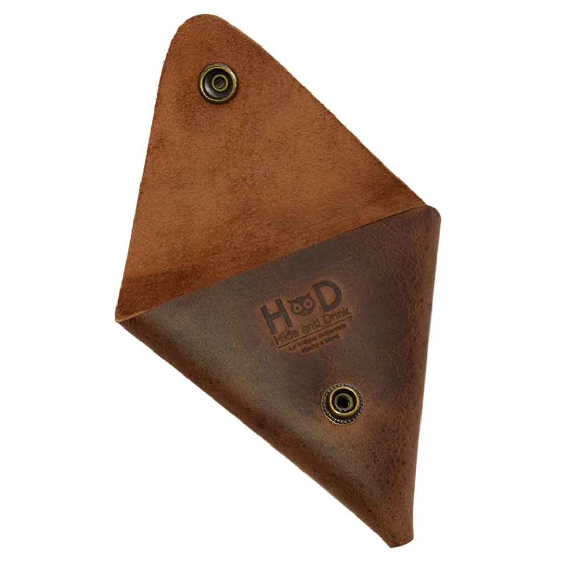 The back of the Triangle Coin Pouch by Hide & Drink, showcasing the neat stitching and branding. This Triangle Coin Pouch is crafted from high-quality Full Grain Leather, perfect for keeping your cash, SD cards, and cords organized. Enjoy the artisan craftsmanship in this handmade item, fire branded and created in La Antigua Guatemala & Oaxaca Mexico.