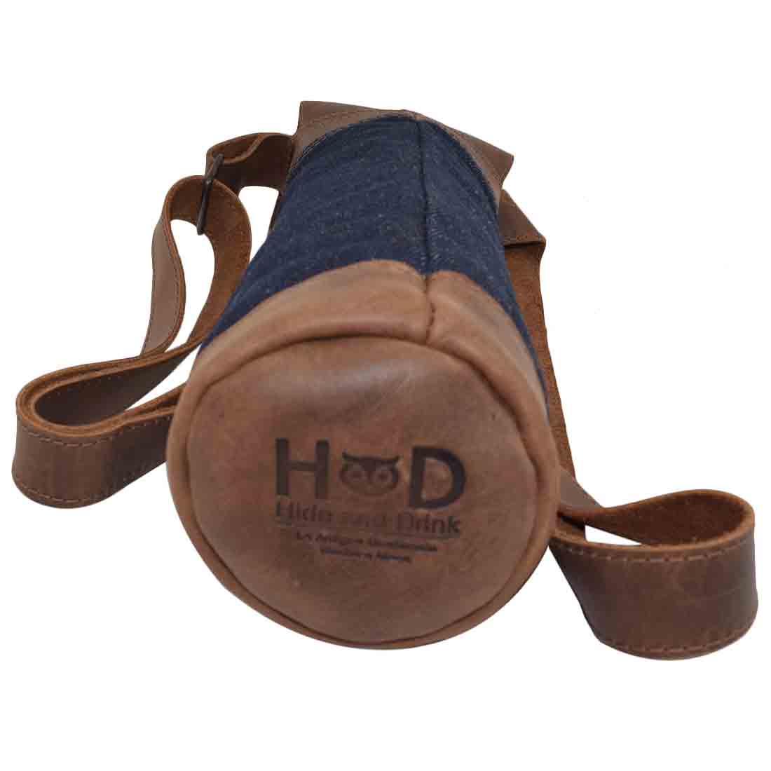 Durable Hide & Drink Wine Caddy showcasing a unique repurposed denim and full grain leather construction. This artisan wine carrier tote is hand cut, hand sewn, and fire branded, embodying small batch production by skilled artisans in La Antigua Guatemala and Oaxaca Mexico.