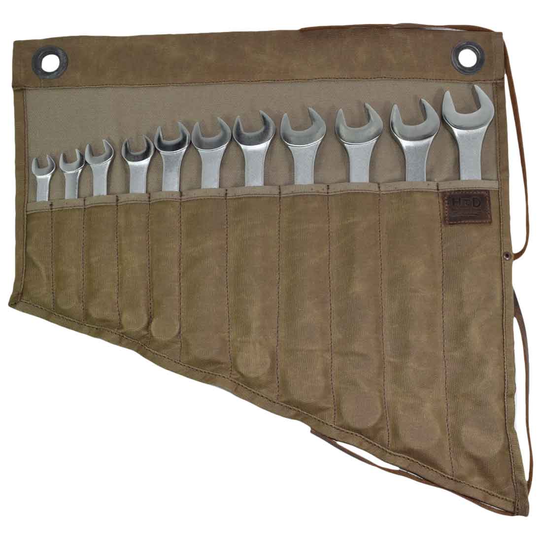 Hide & Drink's Wrench Roll (11 Pockets) revealing a rustic style filled with wrenches. This Wrench Tool Roll makes for effective hanging storage for craftsmen, showcasing ample tool storage. Crafted from high-quality waxed canvas, it is a rustic organizer featuring small batch production, hand cut and hand sewn details, and fire branded craftsmanship, handmade in La Antigua Guatemala & Oaxaca Mexico.