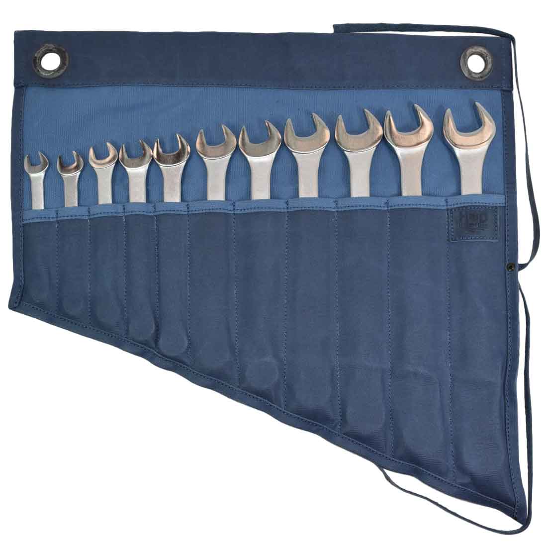 Hide & Drink's Wrench Roll (11 Pockets) filled with wrenches in a striking blue color. This Wrench Tool Roll is perfect for craftsmen seeking organized hanging storage. Made from durable waxed canvas, this rustic organizer features hand cut and hand sewn craftsmanship, showcasing small batch production and fire branding, artisan crafted in La Antigua Guatemala & Oaxaca Mexico.