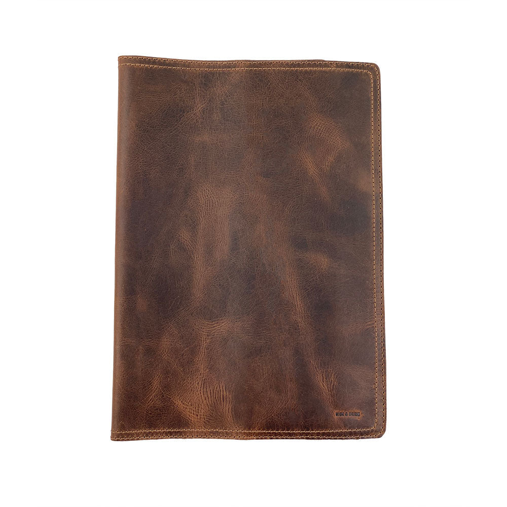 The exterior view of the Hard Cover Notebook Protector (Notebook NOT Included) by Hide & Drink, highlighting its rich leather texture. Designed for Moleskine Hard Cover Sketchbook XXL Size (8.5 x 11 in.), this leather journal cover features Full Grain Leather from StockyardX, showcasing small batch production that is hand cut, hand sewn, and fire branded. Artisan-made in La Antigua Guatemala & Oaxaca Mexico.