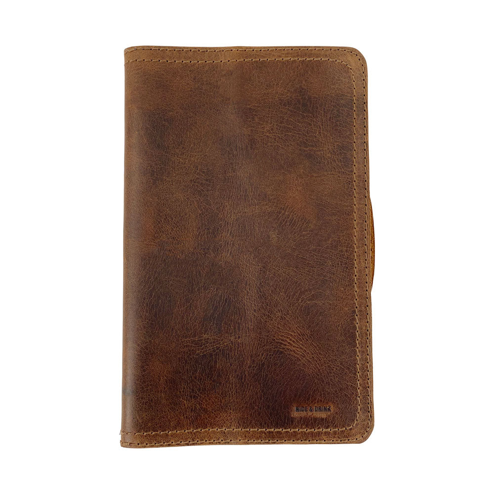 An aesthetic shot of the Hard Cover Notebook Protector (Notebook NOT Included) by Hide & Drink, emphasizing its design and finish. This journal cover is compatible with Moleskine Hard Cover Sketchbook XXL Size (8.5 x 11 in.), Notebook NOT Included, using quality Full Grain Leather from StockyardX known for small batch production that is hand cut, hand sewn, and fire branded by artisans. Handmade in La Antigua Guatemala & Oaxaca Mexico.