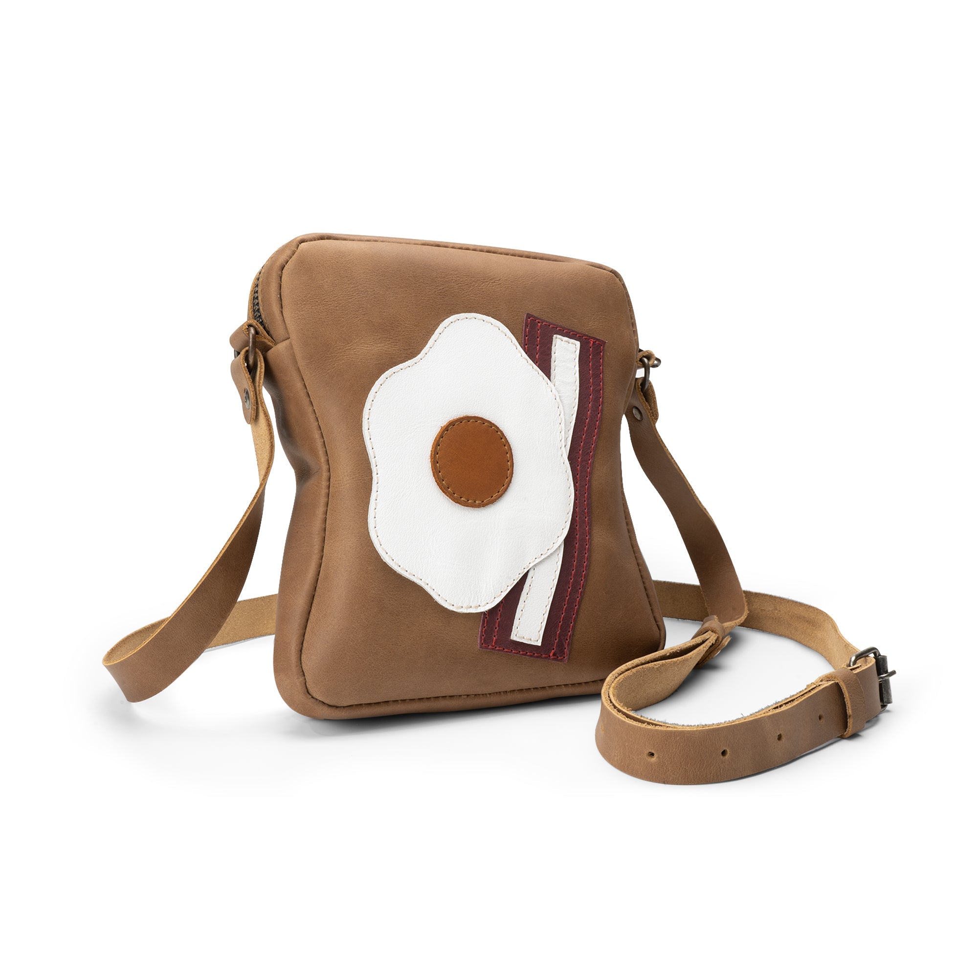 Stylish Egg and Bacon Sandwich-Shaped Shoulder Bag by Tudi Frudi, showcasing a unique design with an adjustable strap. Perfect as a Handbag, Crossbody Bag, or Messenger Bag, made from Full Grain Leather through Small Batch Production, Hand Cut, and Hand Sewn techniques. Artisan quality, Handmade in La Antigua Guatemala.