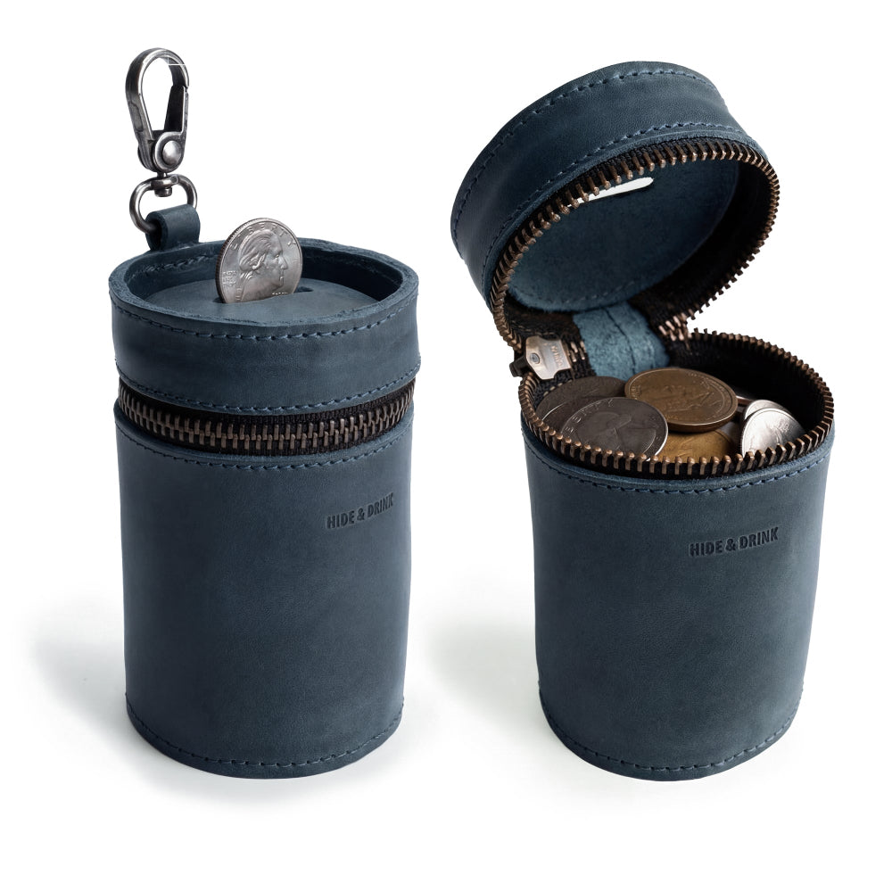 Hide & Drink Bucket Coin Release showcasing a stylish blue piggy bank bucket. This money box is a zippered pouch and cash organizer made from full grain leather. A perfect coin case handcrafted in La Antigua Guatemala & Oaxaca Mexico, featuring small batch production and artisan quality.