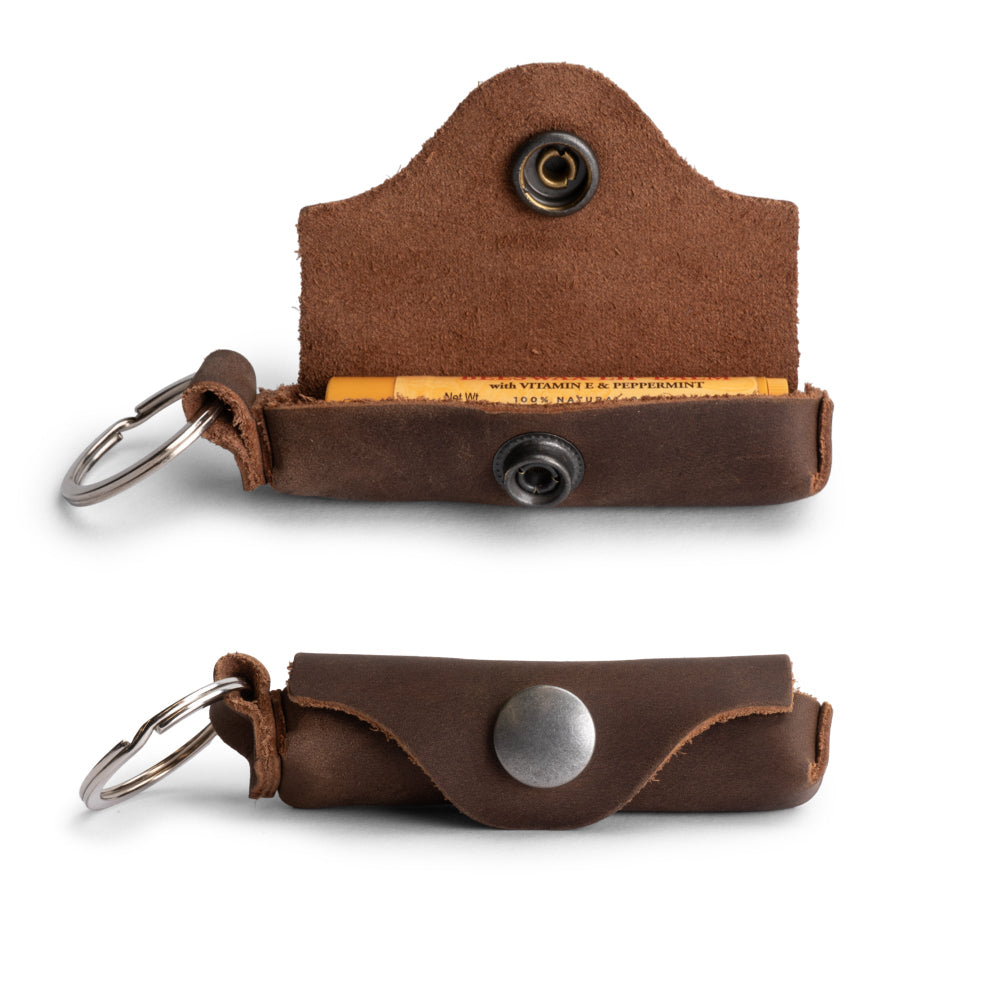 Heather's Lip Balm Keychain - An open and functional Lip Balm Keychain Holder made from attractive Full Grain Leather. This handmade piece provides convenient lips protection on the go and makes for a thoughtful commuter gift. Hand cut and fire branded, it showcases the artisanship of La Antigua Guatemala and Oaxaca Mexico.