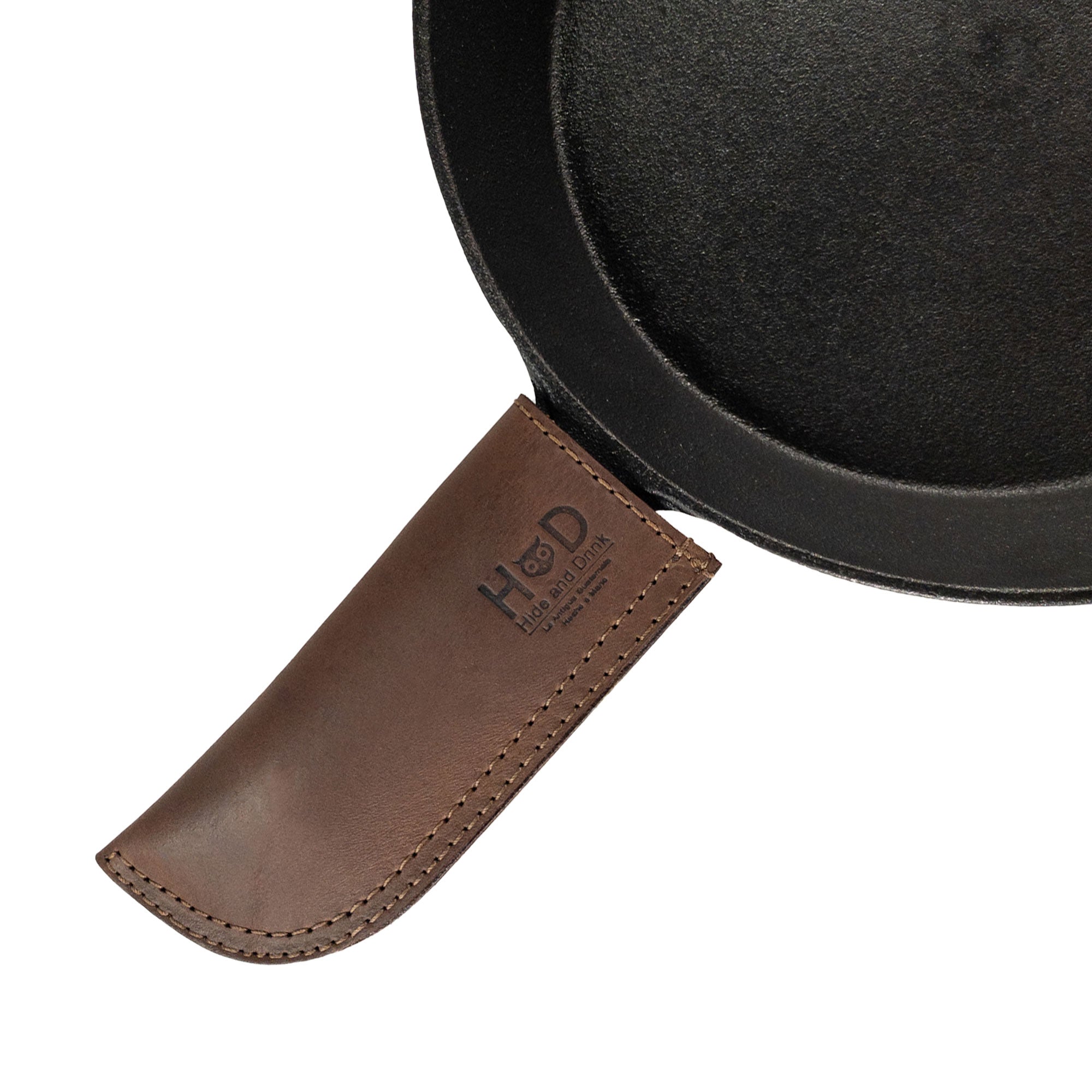 Hot Pan Handle Cover by Hide & Drink, showcasing the heat resistant and sturdy grip design for cast iron skillets and frying pans. Made from simple, durable full grain leather, handmade in La Antigua Guatemala & Oaxaca Mexico.
