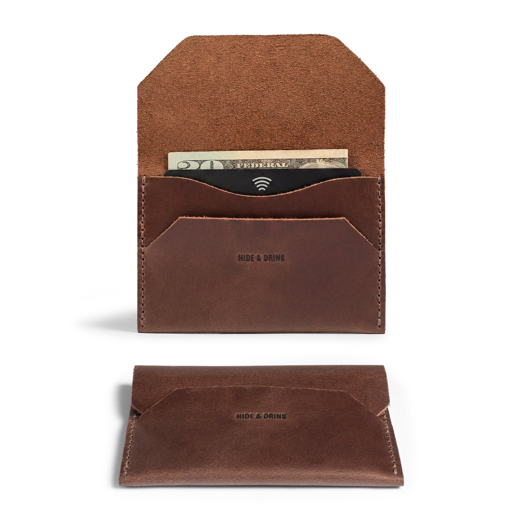 The Enfold Card Wallet by Hide & Drink showcases a beautiful leather card wallet with a slim design for front pocket use. This compact credit card holder for men features cash storage and a minimalist thin business card organizer style. Made from full grain leather, it reflects the quality of small batch production, hand cut and hand sewn, with fire branding, highlighting its artisan craftsmanship from La Antigua Guatemala and Oaxaca Mexico.