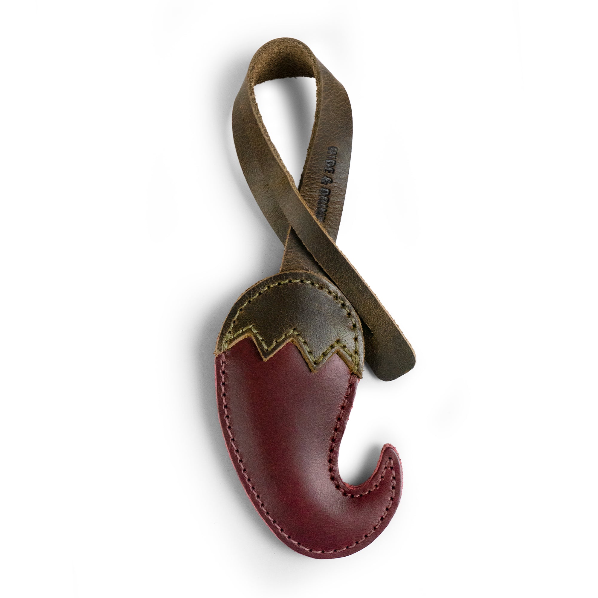 The Hot Pepper Bag Charm by Hide & Drink showcases a unique design made from full grain leather, perfect for accenting your handbags or backpacks. This artisan piece is handcrafted in La Antigua Guatemala & Oaxaca Mexico, utilizing small batch production techniques to ensure quality. It's an ideal ornament for women seeking stylish purse charm options, highlighting its fire-branded craftsmanship.