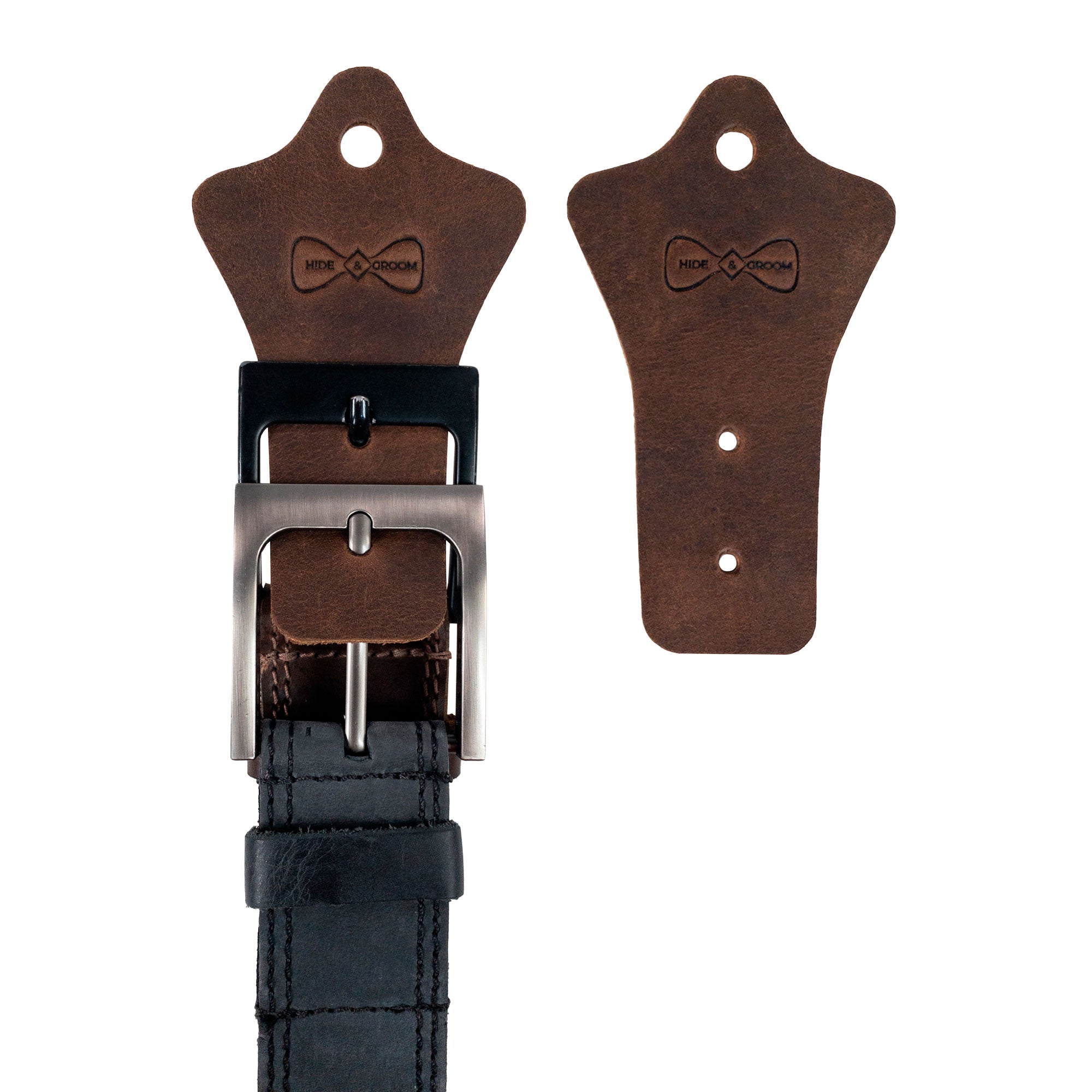 Hide & Groom Set of 2 Buckle Belt Hangers displayed with a belt, perfect for organizing in closets or entryways. These handcrafted full grain leather accessories are ideal for groomsmen or best man, showcasing rustic charm. Handmade in La Antigua Guatemala, these artisan belt hangers are fire branded, and designed for small batch production.